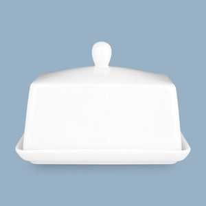 White ceramic butter dish with lid on a light blue background - Wilkie Brothers Butter Dish NZ